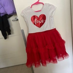 Red and white dress with a heart and the word love and a sparkly red bottom